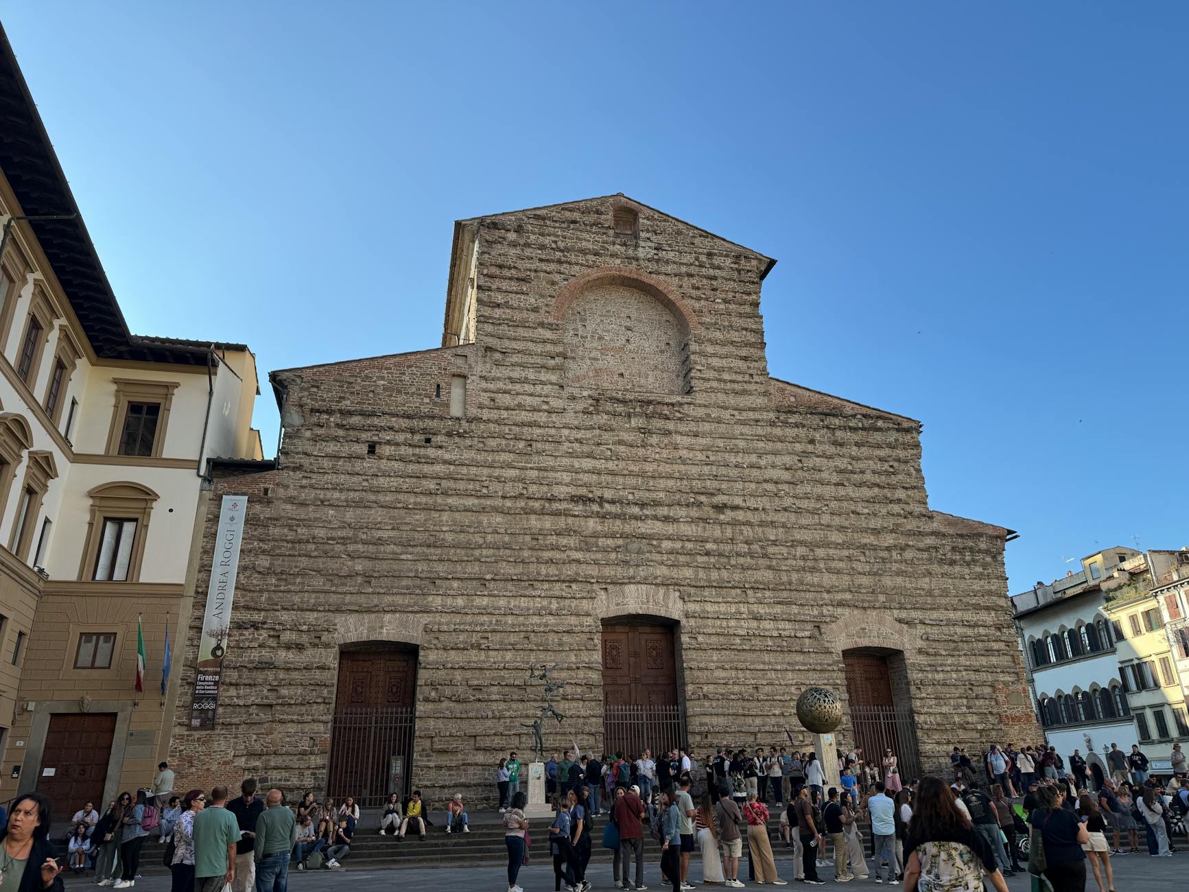 Tourists in a Florence piazza during summer travel season
