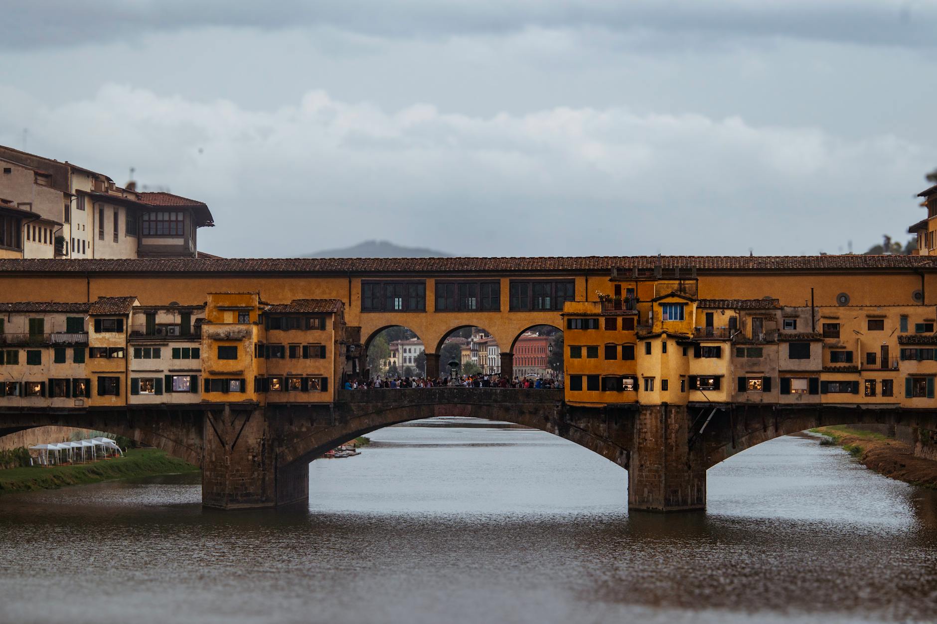 Scenic view of the historic Ponte Vecchio bridge spanning the Arno River in Florence, Italy.