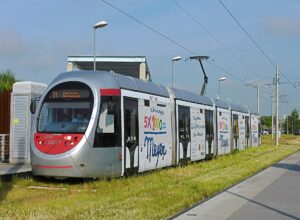 A silver Florence T1 tram at the Villa Costanza terminus, signed for Careggi Ospedale, standing on a grassed track beside a platform