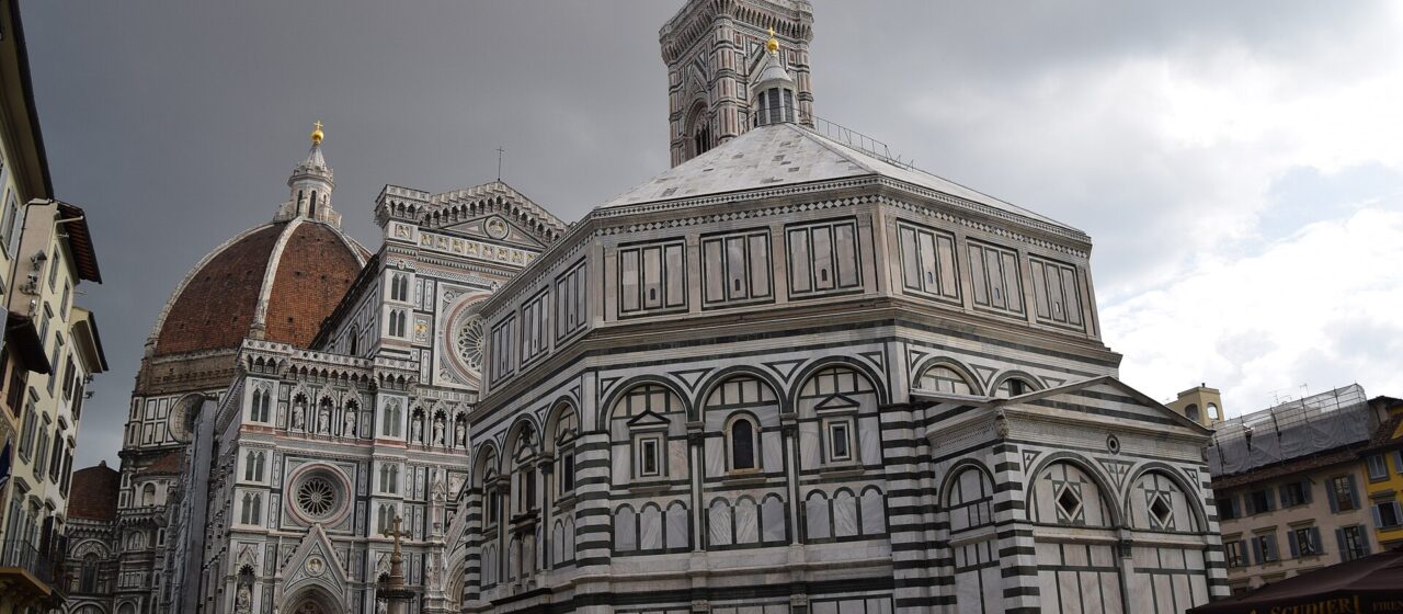 The Baptistery, cathedral facade, Giotto's bell tower and Brunelleschi's dome seen together across Piazza del Duomo in Florence