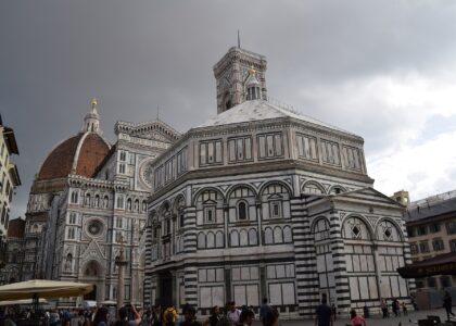 The Baptistery, cathedral facade, Giotto's bell tower and Brunelleschi's dome seen together across Piazza del Duomo in Florence