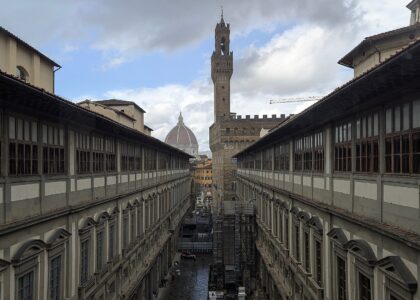 The Piazzale degli Uffizi courtyard in Florence seen from above, with Palazzo Vecchio's tower and the Duomo beyond