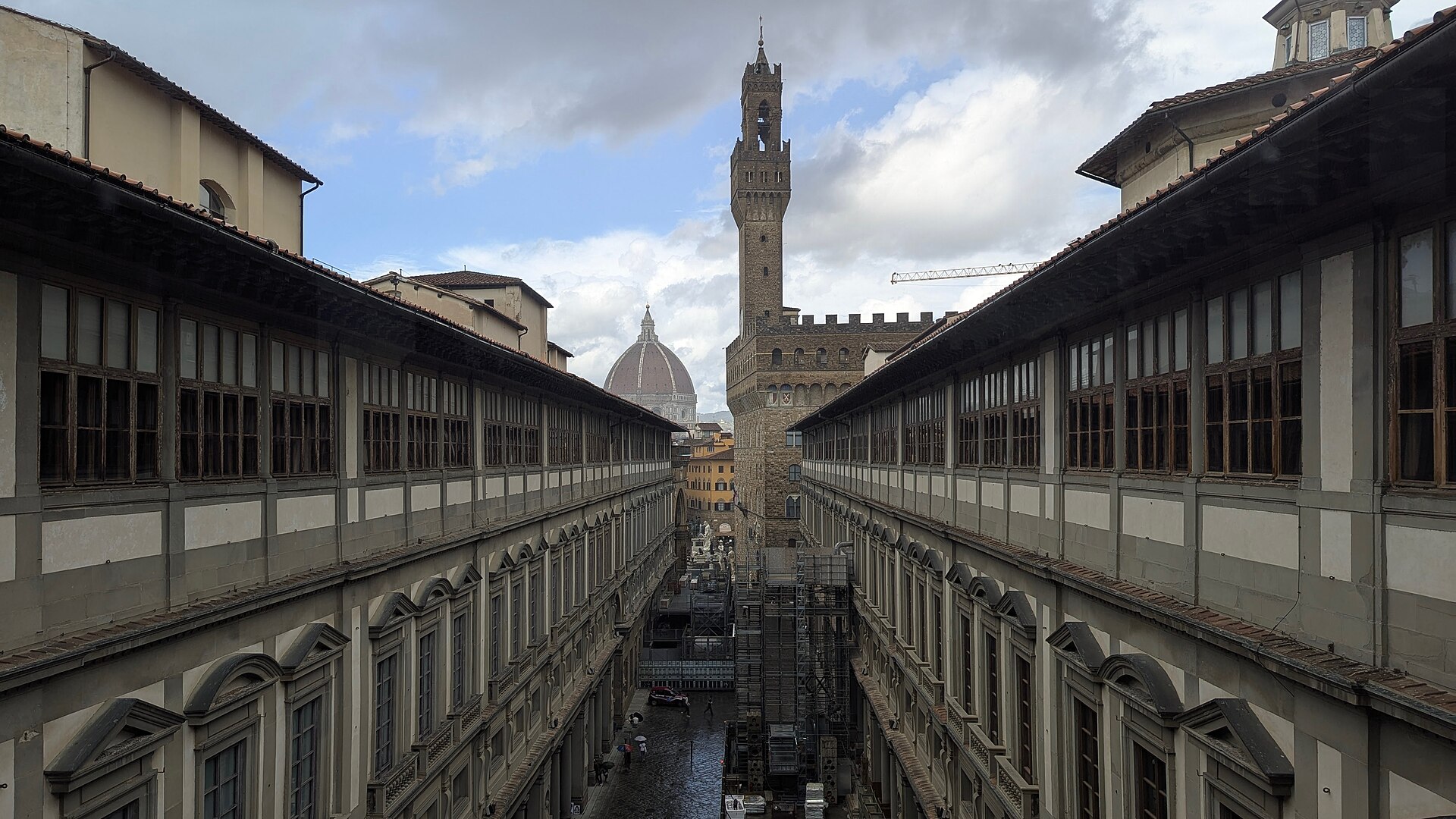 The Piazzale degli Uffizi courtyard in Florence seen from above with Palazzo Vecchio's tower beyond
