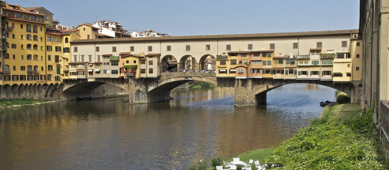 Ponte Vecchio in Florence with the plain upper storey of the Vasari Corridor and its row of small square windows running above the shops