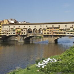 Ponte Vecchio in Florence with the plain upper storey of the Vasari Corridor and its row of small square windows running above the shops