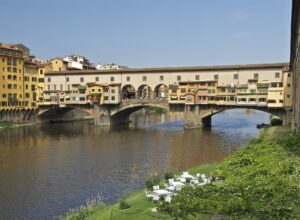Ponte Vecchio in Florence with the plain upper storey of the Vasari Corridor and its row of small square windows running above the shops