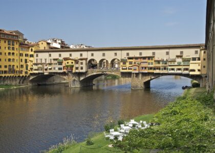 Ponte Vecchio in Florence with the plain upper storey of the Vasari Corridor and its row of small square windows running above the shops
