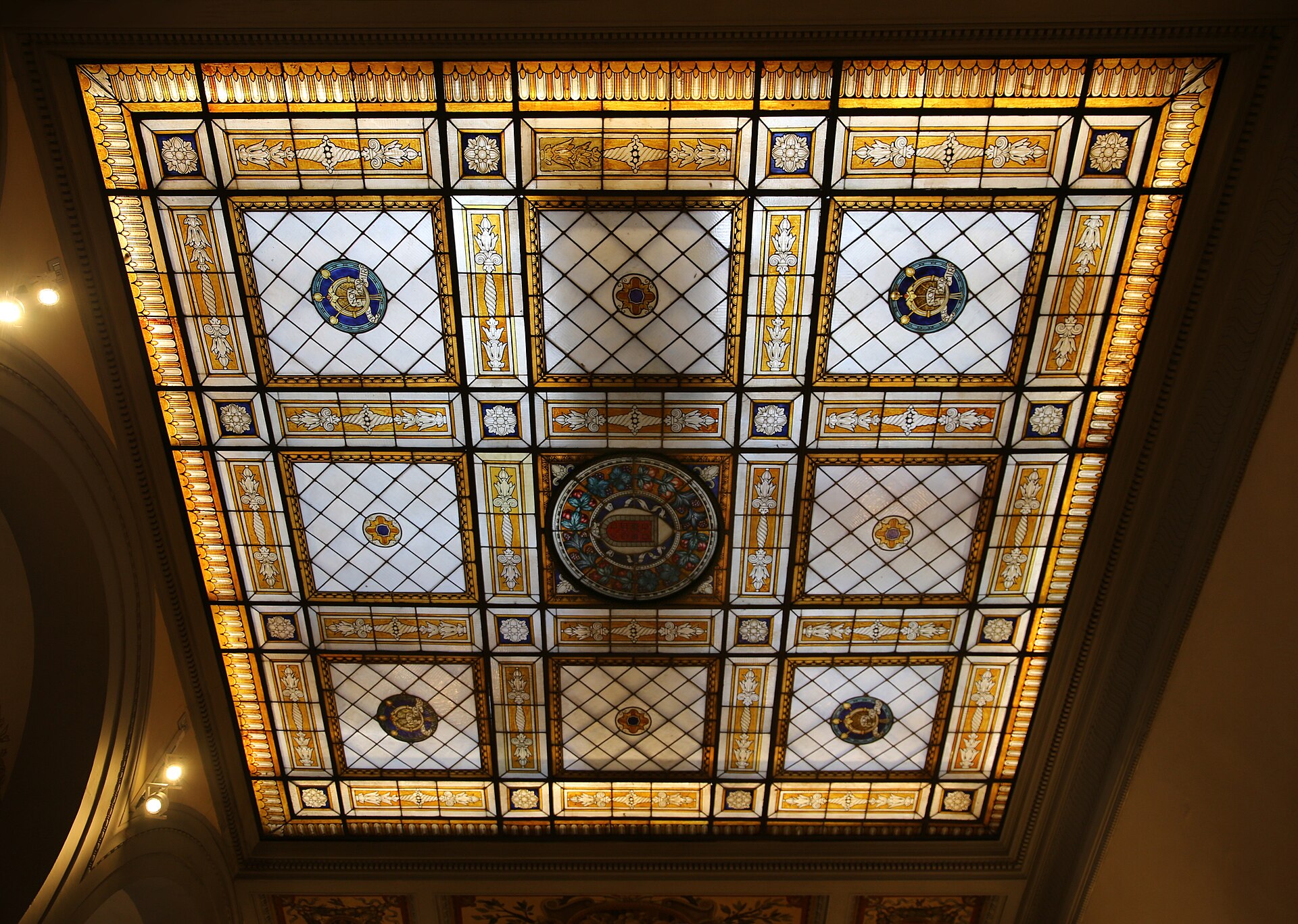 Amber borders and colored medallions decorate the stained-glass skylight inside Florence’s Hotel Porta Rossa.