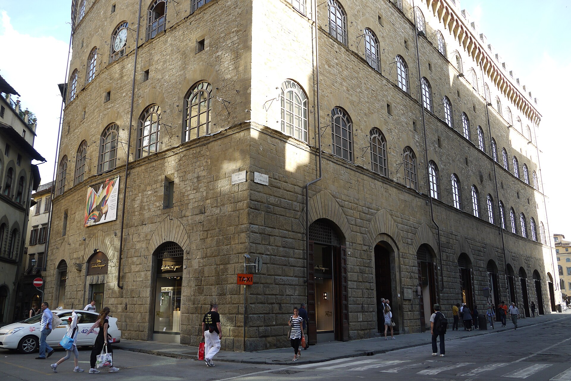 Ferragamo shop windows occupy the arched ground floor of Florence's stone Palazzo Spini Feroni as pedestrians pass.