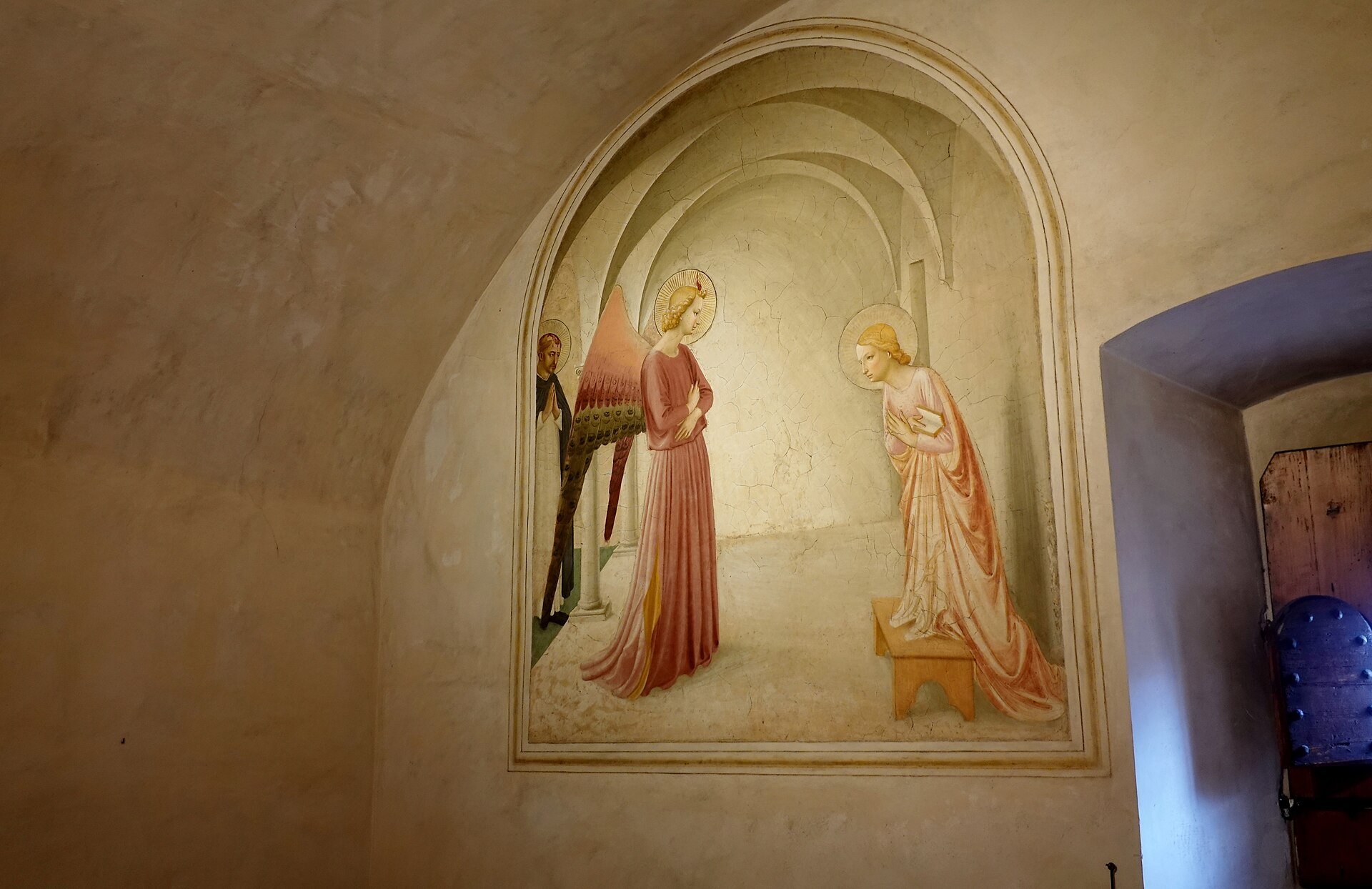 Fra Angelico's Annunciation fills an arched panel beside a shuttered window in Cell 3 of Florence's San Marco convent.