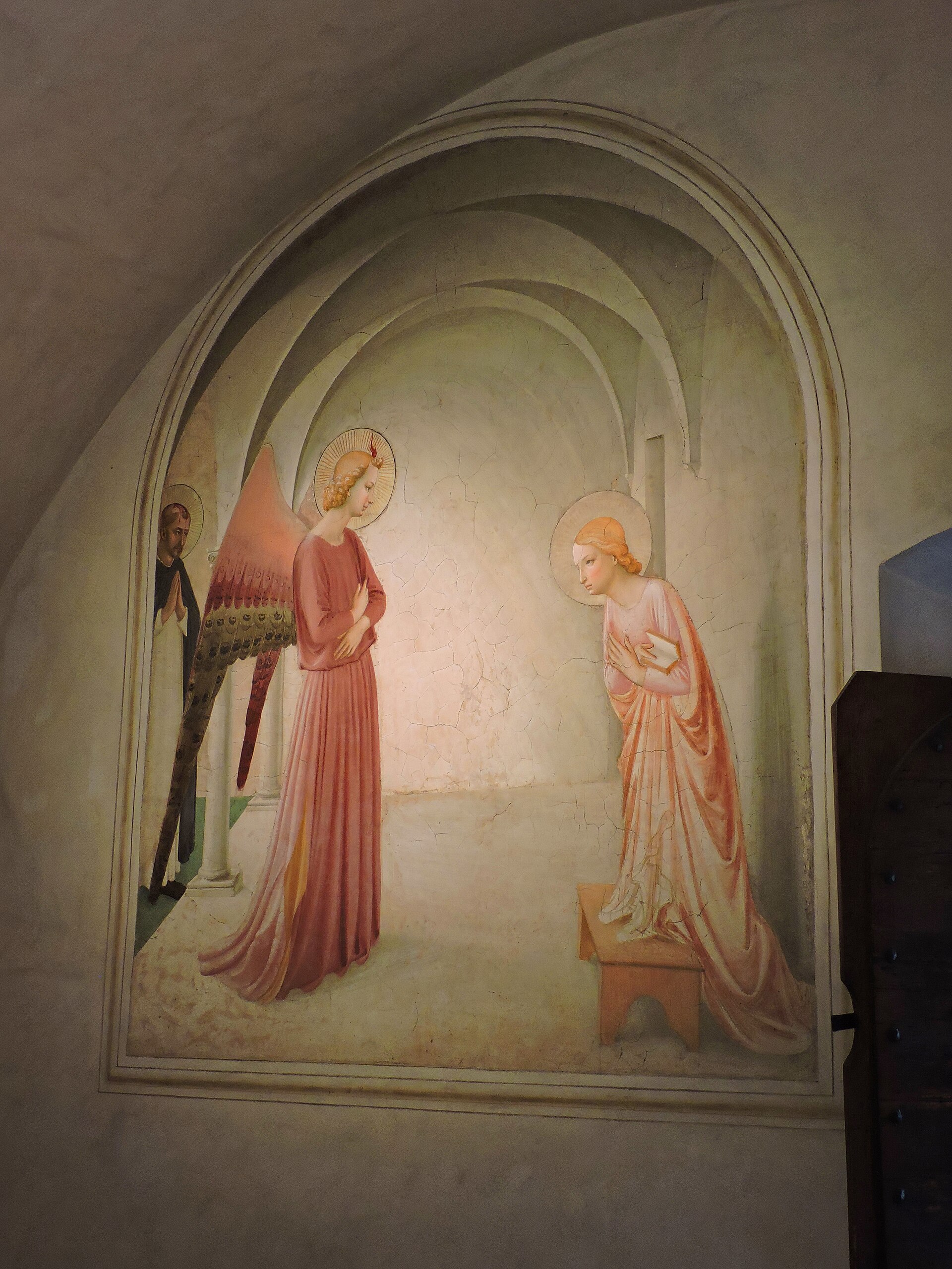Gabriel and Mary face one another in Fra Angelico's arched Annunciation fresco inside Cell 3 at Florence's San Marco.
