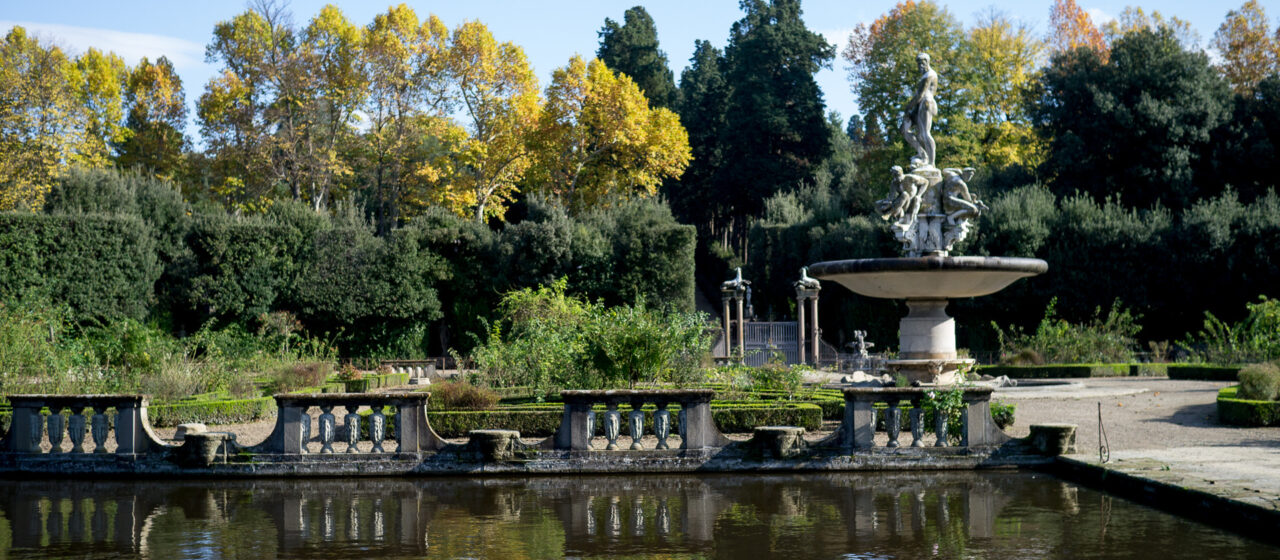 Golden trees and the Oceanus fountain reflect in the pond surrounding the Isolotto in Florence’s Boboli Gardens.