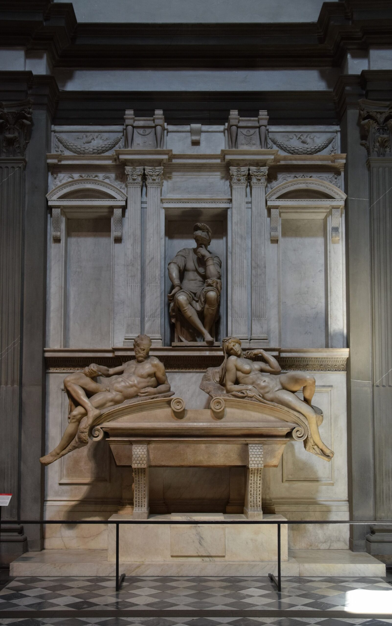 Michelangelo's tomb of Lorenzo de' Medici places a seated figure above Dawn and Dusk in Florence's New Sacristy.