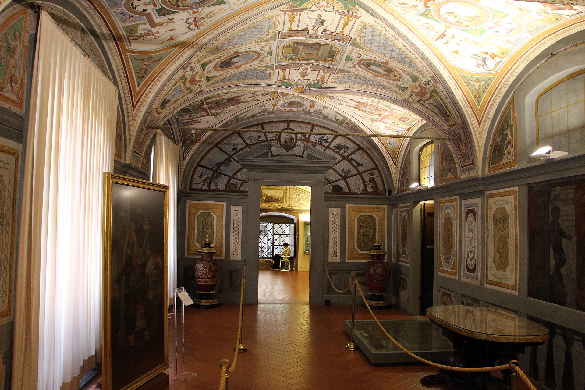 Painted vaults and patterned walls surround benches and a table in the Treasury of the Grand Dukes at Florence's Palazzo Pitti.