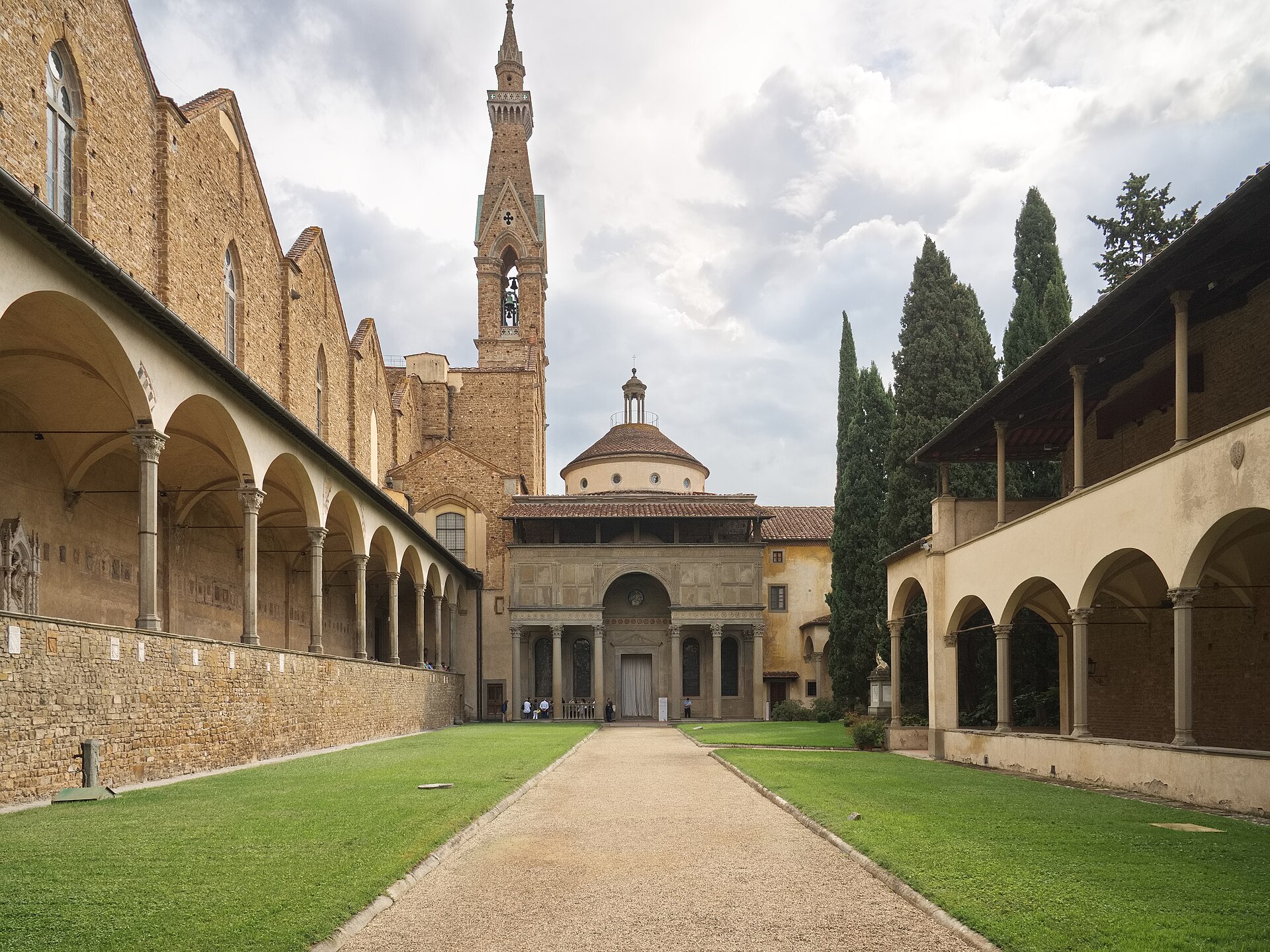 A path between lawns and cloister arcades leads to the domed Pazzi Chapel at Santa Croce in Florence.