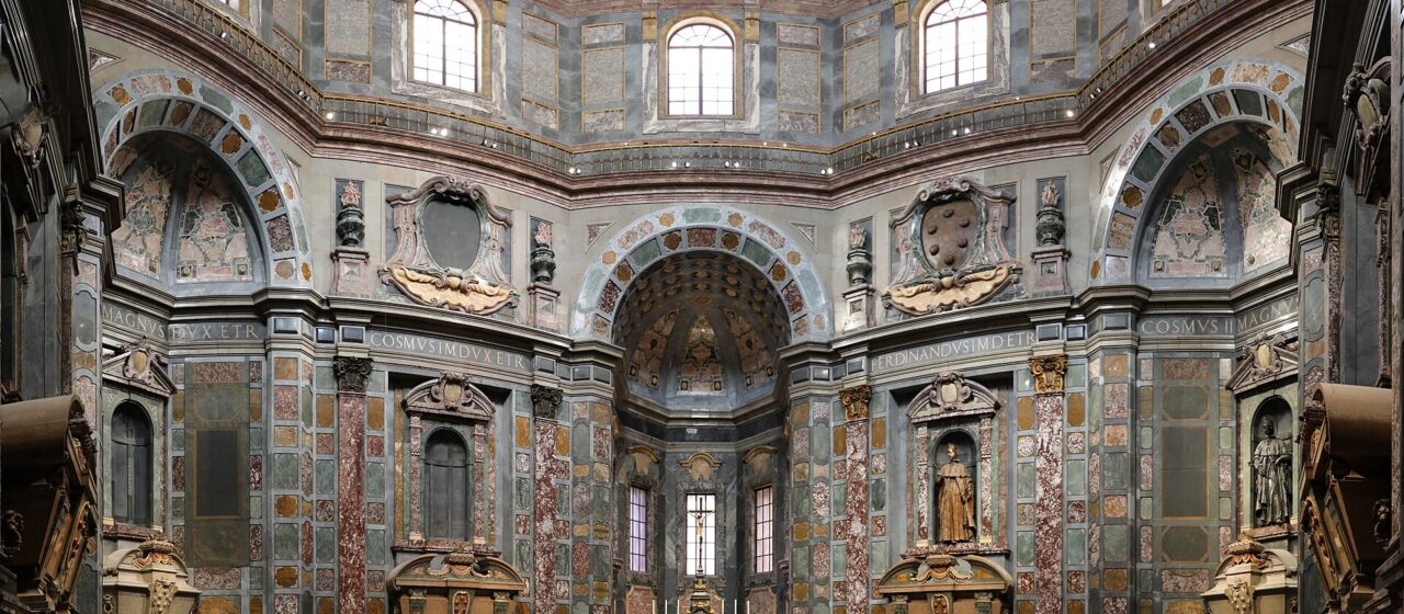 Patterned stone floors and richly coloured walls rise beneath the painted dome of the Princes' Chapel in Florence.